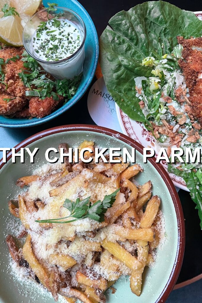 Savor the vibrant colors and tantalizing textures of this mouth-watering chicken dish served atop a bed of crispy fries, with fresh greens adding a delightful contrast.