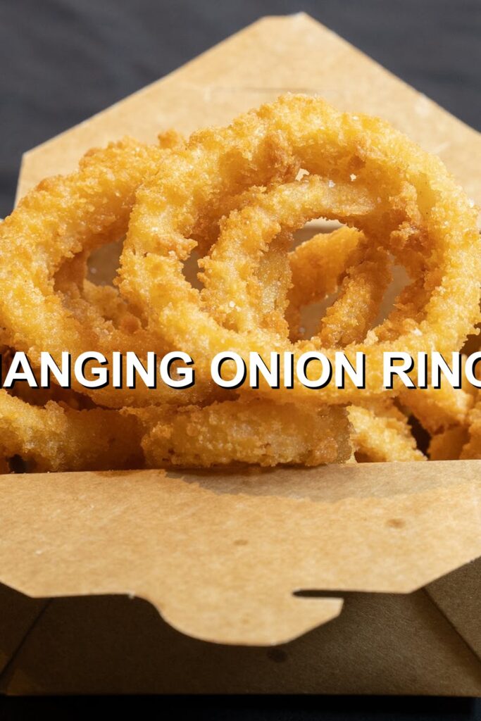Crispy golden-brown, perfectly fried onion rings showcasing their delicious textural contrast.