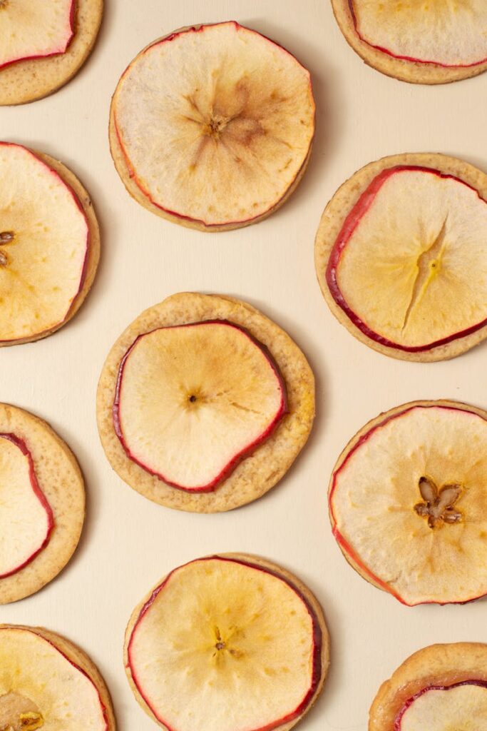 Crispy baked apple slices with a golden-brown crust, garnished with vibrant red radishes.